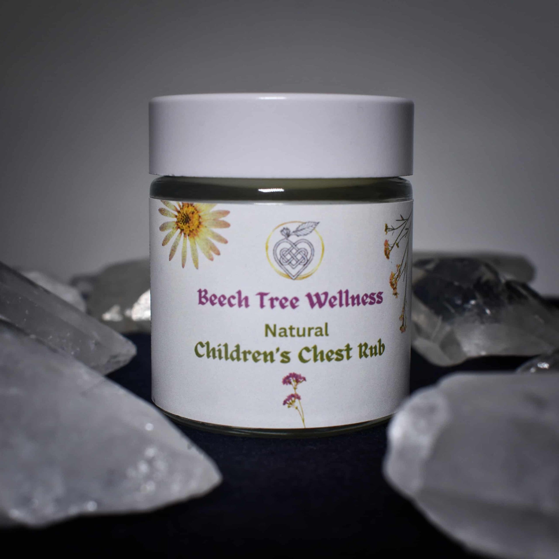 Jar of Beech Tree Wellness Natural Children's Chest Rub with a floral label on a dark background.
